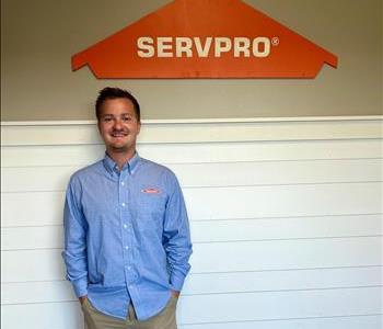 Male employee in front of SERVPRO sign.